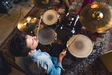 high-angle shot of a drummer man playing in the studio, music band concept. High quality photo