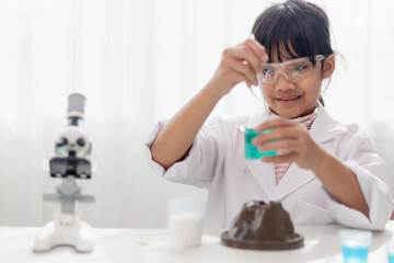 Naklejka premium education, science, chemistry and children concept - kids or students with test tube making experiment at school laboratory