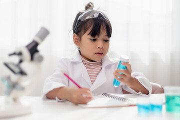 education, science, chemistry and children concept - kids or students with test tube making experiment at school laboratory