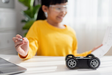 Asia students learn at home in coding robot cars and electronic board cables in STEM, STEAM, mathematics engineering science technology computer code in robotics for kids concept.