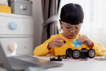 Asia students learn at home in coding robot cars and electronic board cables in STEM, STEAM, mathematics engineering science technology computer code in robotics for kids concept.