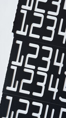 torn paper stencils with numbers on white