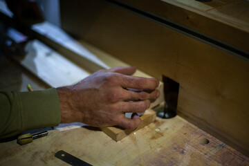 Wood processing. Carpenter's hand. Details of work in carpentry workshop.