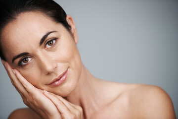 Beauty with no best-before date. Cropped studio shot of a beautiful mid adult woman touching her...