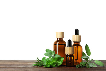 Bottles of essential oil and fresh herbs on wooden table against white background