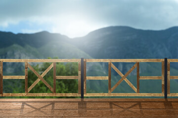 Outdoor wooden terrace revealing picturesque view on mountains in morning