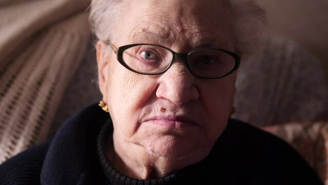 beautiful portrait of alone ederly  woman looking at the camera - old age