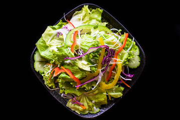 Fresh Vietnamese salad with vegetables on black background top view