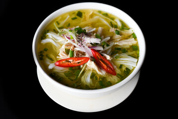Chicken soup Pho ga in vietnamese style on black background - obrazy, fototapety, plakaty