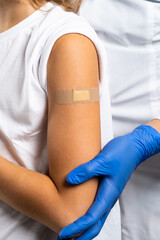 vaccination of children, a little boy at a doctor's appointment, children's medicine, injection in the arm, vertical close-up photo