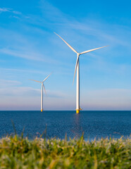 view at Windmill park with wind mill turbines during winter generating electricity with a blue sky...