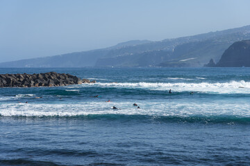 A group of surfers on the waves. Tenerife. Canary Islands. Spain