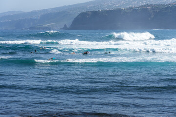 A group of surfers on the waves. Tenerife. Canary Islands. Spain