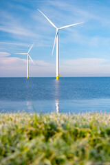 Aerial view at Windmill park with windmills turbines during winter generating electricity with a...