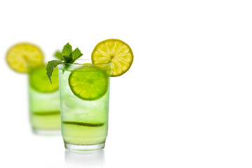 Summer cocktail with ice cube, garnished with a lime slice and mint isolated on a white background. space for text. 
