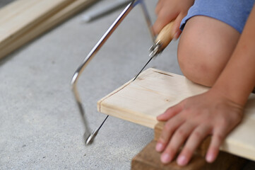 子供の夏休みの木工の宿題で糸鋸を使って切断