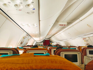 Fototapeta premium View from passenger seat in the commercial airline cabin.