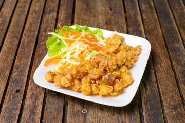 Deep fried chicken tendons on the white dish.