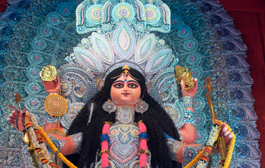 A gorgeous looking divine idol of Hindu Goddess Jagatdhatri / Jagaddhatri inside puja pandal. Shot...