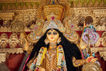 A gorgeous looking divine idol of Hindu Goddess Jagatdhatri / Jagaddhatri inside puja pandal. Shot...