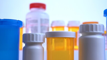 Different pills bottles macro close up shot. Pharmacy table. Modern drug and pharmacy industry concept. Research and development medicines to prevent or treat coronavirus COVID idea.