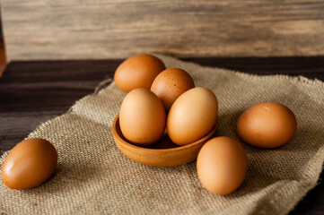 Raw egss on wooden background, the source protein for health lovers