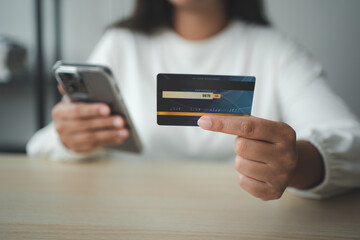 Woman using smart phone and credit card make money transaction online service or online shopping