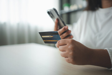 Woman using smart phone and credit card make money transaction online service or online shopping