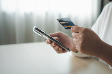 Woman using smart phone and credit card make money transaction online service or online shopping