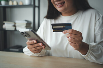 Woman using smart phone and credit card make money transaction online service or online shopping