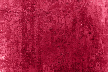 Rough grunge surface of shabby worn plastered wall toned with Viva Magenta color. Abstract vintage...