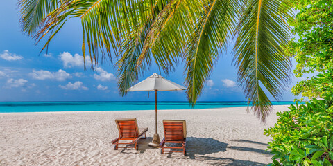 beach with palmBeautiful tropical island scenery, couple sun beds, umbrella under palm tree....