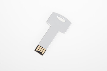 Silver modern Usb stick shaped like a key flash drive on white background