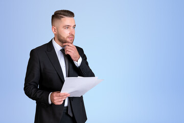 Dreaming handsome businessman wearing formal suit standing holdi