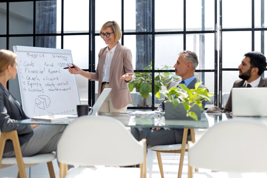 Business conference presentation with team training flipchart office.