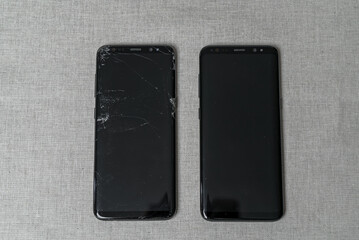 Display smartphone with broken screen and new one. top view