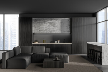 Dark studio interior with soft place and dining zone, panoramic window