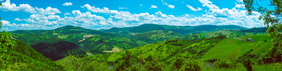 huge horizontal wide panorama of green Italian hills sunny day background