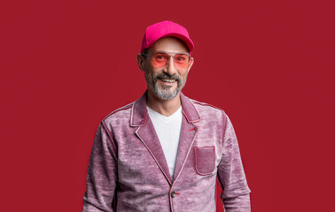 mature stylish man wear cap isolated on red background. mature stylish man in studio. mature man