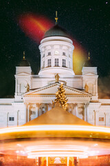 Night Dark Blue Sky Glowing Stars Background. Helsinki, Finland. Xmas Christmas Market On Senate Square With Holiday Carousel And Famous Landmark Is Lutheran Cathedral In Winter Night.