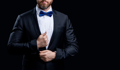 cropped photo of tuxedo man in formal suit. formal tuxedo man isolated on black background