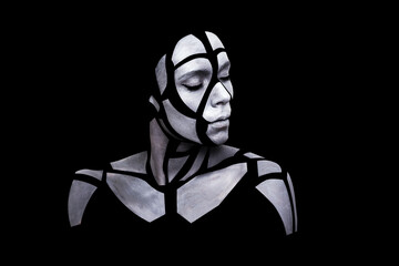 Portrait of a young woman with bold grey glowing makeup posing in the studio. Shape of gray polygons on female face. Pieces of face isolated on black background.