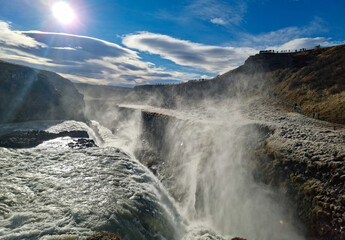 Majestic scenic view of a Gullfoss Waterfall with mist and breeze in Godlen Circle under a sunny sky in Iceland