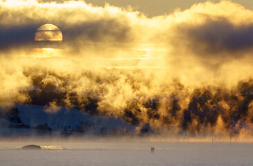 Sunset in the fog over a lake in Norway. 