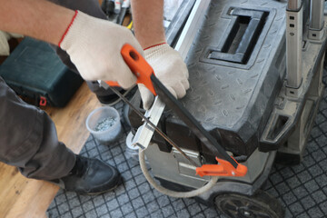 worker performs work on trimming and installs a metal plate and fitting