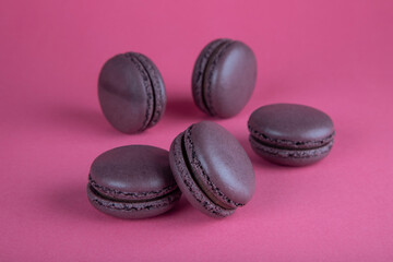 Closeup of brown macaroon cakes on red background