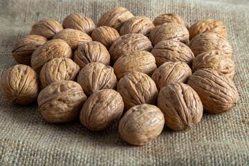 Whole shell walnuts on burlap sack