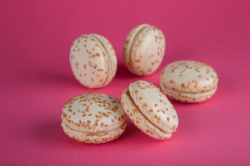 Close-up of sesame macarons cakes on red background