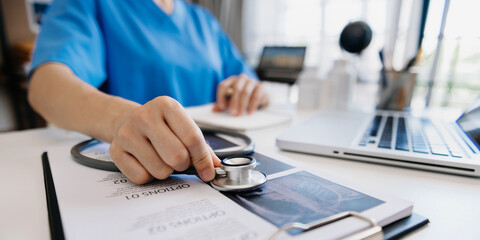 Medicine doctor and stethoscope using notepad, and tablet with  medical network connection and growth chart on laptop, background