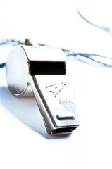 close up of a metal referee whistle